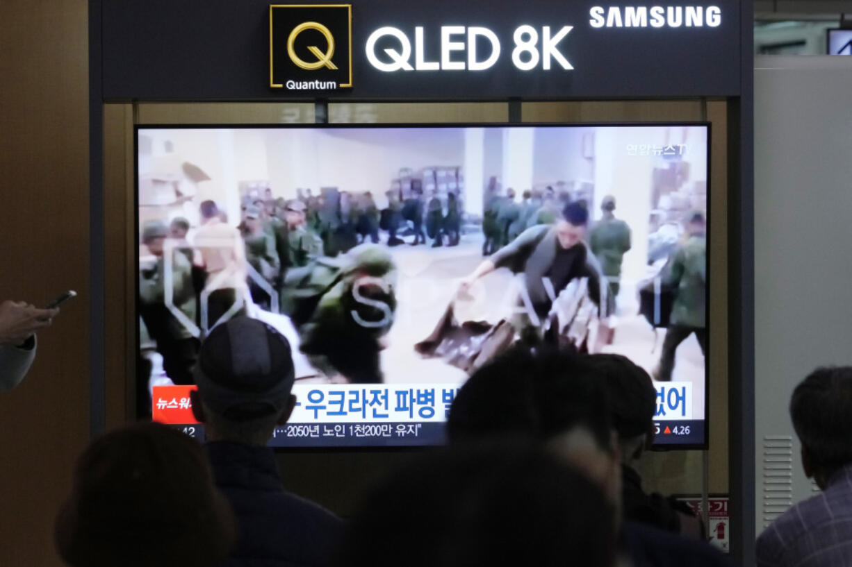 FILE - A TV screen shows an image of soldiers believed to be from North Korea stand in line to receive supplies from Russia during a news program at Seoul Railway Station in Seoul, South Korea, on Oct. 21, 2024.