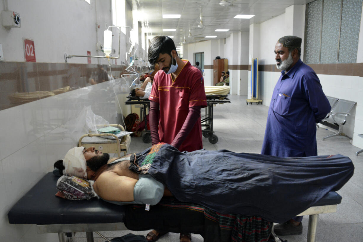 Injured men receive treatment at a hospital in Quetta, Pakistan, Friday, Oct. 11, 2024, following Thursday attack by gunmen in Balochistan province.