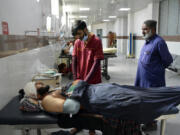 Injured men receive treatment at a hospital in Quetta, Pakistan, Friday, Oct. 11, 2024, following Thursday attack by gunmen in Balochistan province.