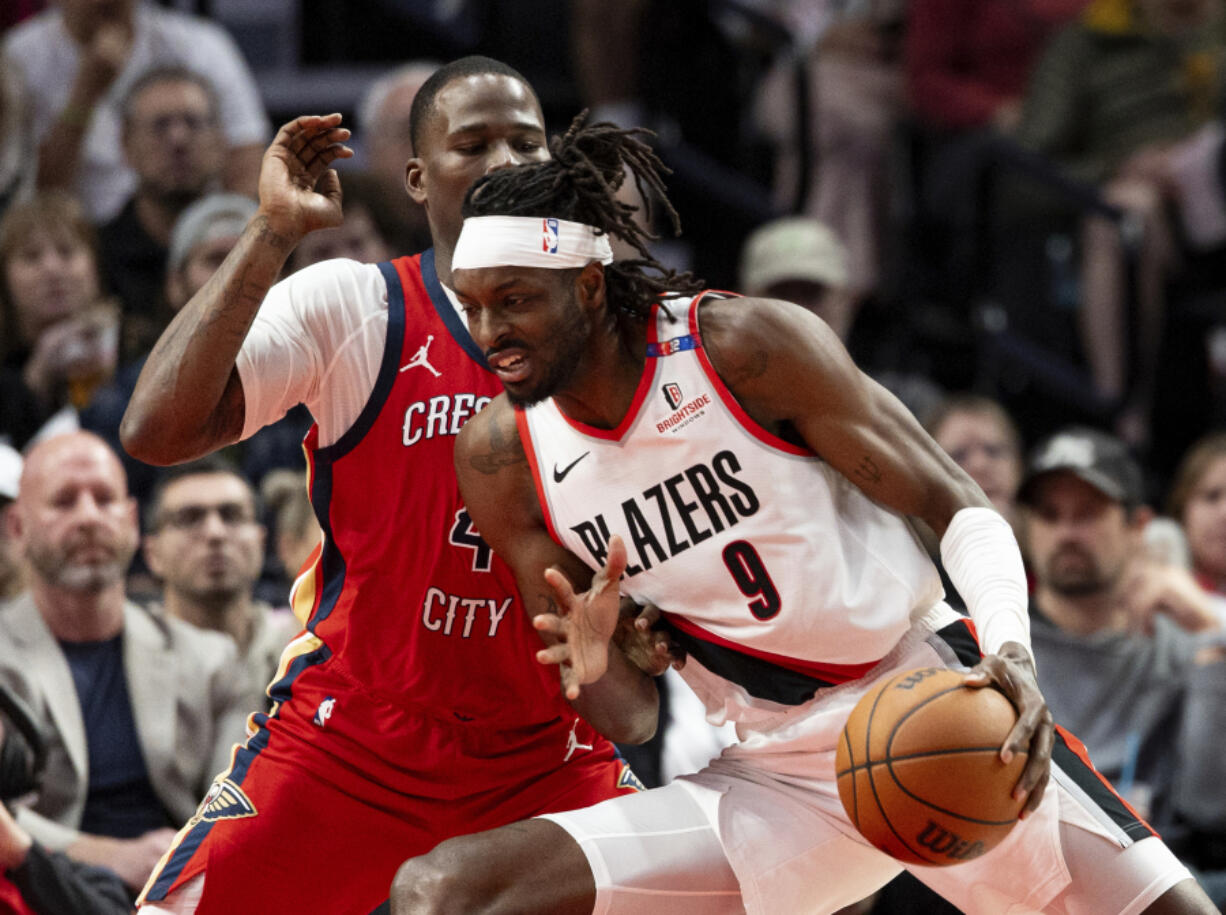 Portland Trail Blazers forward Jerami Grant, right, drives to the hoop against New Orleans Pelicans guard Javonte Green, left, during the second half of an NBA basketball game Sunday, Oct. 27, 2024, in Portland, Ore.