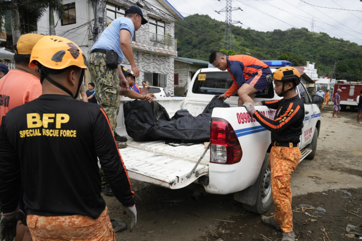 A body is recovered by rescuers after a recent landslide triggered by Tropical Storm Trami struck Talisay, Batangas province, Philippines which thousands homeless and several villagers dead on Saturday, Oct. 26, 2024.