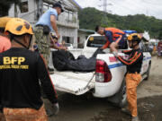 A body is recovered by rescuers after a recent landslide triggered by Tropical Storm Trami struck Talisay, Batangas province, Philippines which thousands homeless and several villagers dead on Saturday, Oct. 26, 2024.