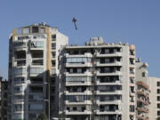 A missile launched from an Israeli jet hits a building in Ghobeiri, Beirut, Lebanon, Tuesday, Oct. 22, 2024.