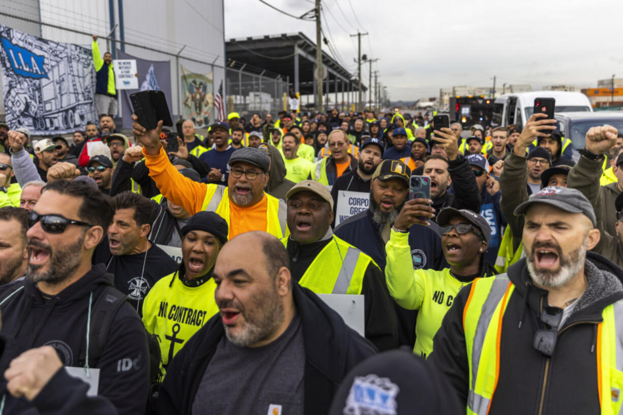 Workers take part in a port strike at Port Newark, Tuesday, Oct. 1, 2024, in Bayonne, N.J.