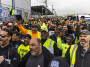 Workers take part in a port strike at Port Newark, Tuesday, Oct. 1, 2024, in Bayonne, N.J.