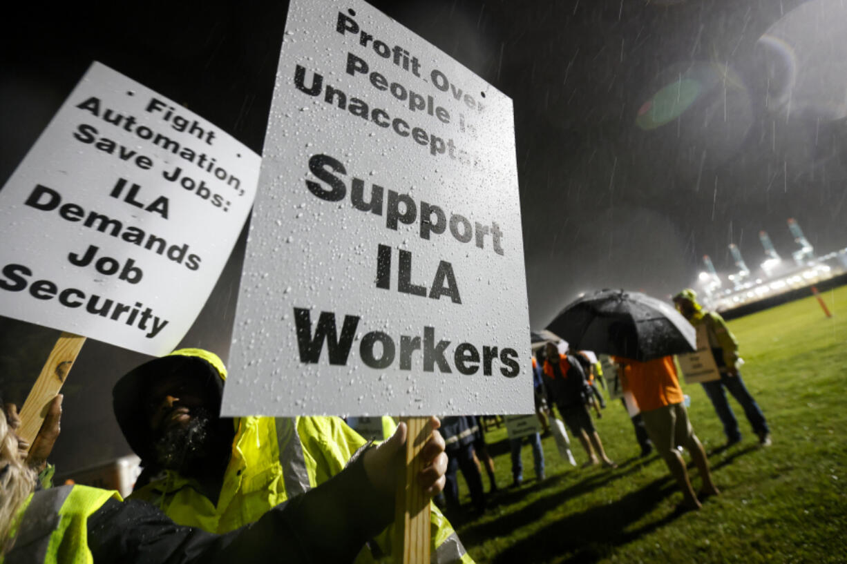 Hundreds of longshoremen strike together outside of the Virginia International Gateway in Portsmouth, Va., Tuesday, Oct. 1, 2024.