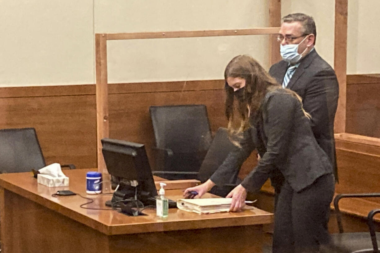 FILE - Former Ohio police officer Adam Coy stands during a Franklin County hearing as defense attorney Kaitlyn Stephens checks her notes, Oct. 4, 2021, in Columbus, Ohio.