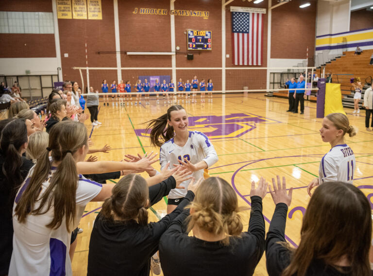 Columbia River sophomore Grace Sheron (12) celebrates with teammates during pregame introductions Wednesday, Oct. 9, 2024, before a match against Ridgefield at Columbia River High School.