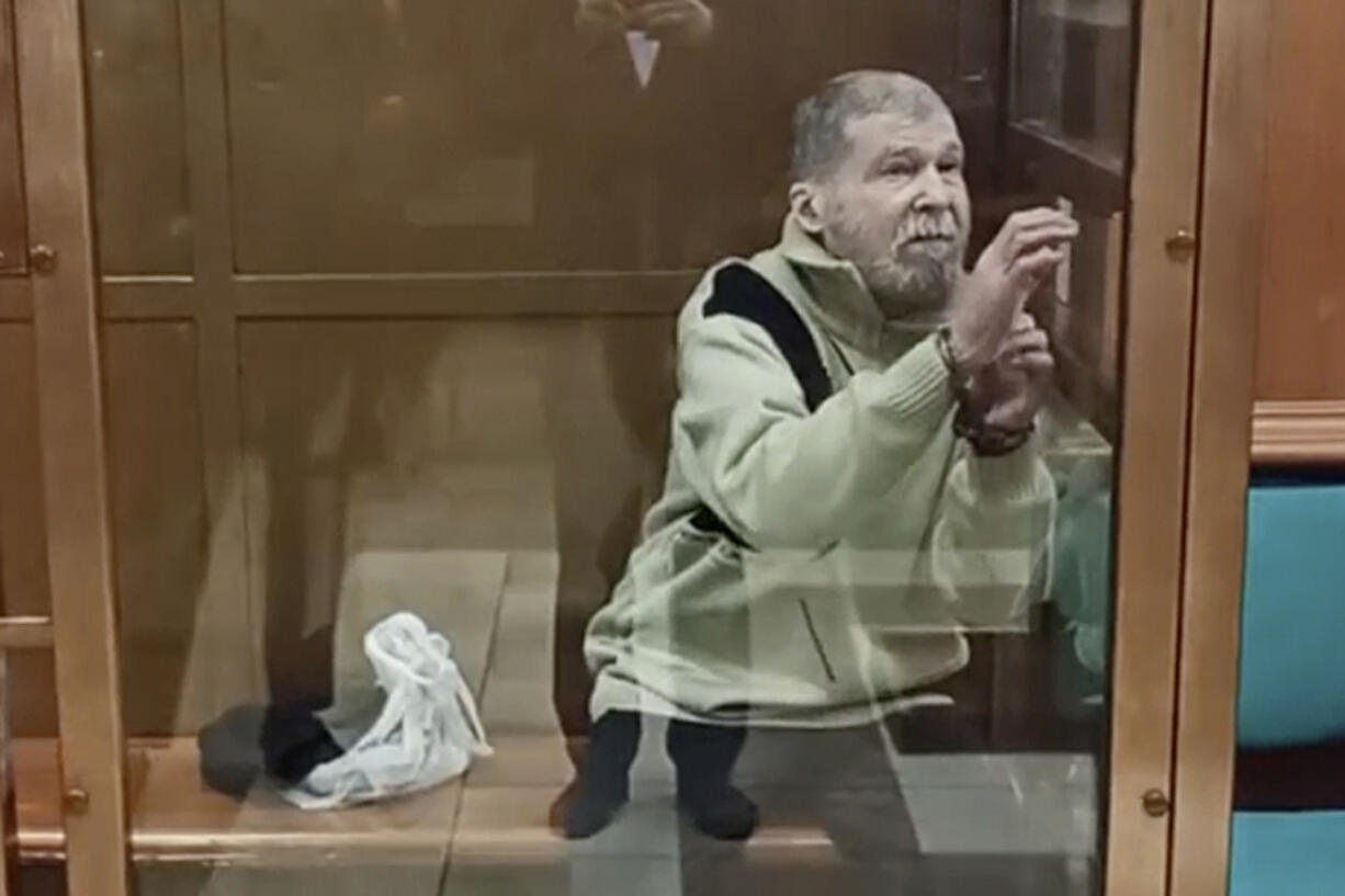 In this photo taken from video released by the Moscow City Court Press Service, Stephen Hubbard, a U.S. citizen accused of fighting as a mercenary in Ukraine against Russia stands in a glass cage during a court session in the Moscow City court in Moscow, Russia, Monday, Oct. 7, 2024.