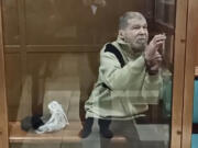 In this photo taken from video released by the Moscow City Court Press Service, Stephen Hubbard, a U.S. citizen accused of fighting as a mercenary in Ukraine against Russia stands in a glass cage during a court session in the Moscow City court in Moscow, Russia, Monday, Oct. 7, 2024.