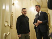 NATO Secretary General Mark Rutte, left, and Ukrainian President Volodymyr Zelenskyy speak in a corridor ahead of a press conference in Kyiv, Ukraine, Thursday Oct. 3, 2024.