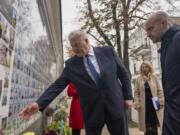 Minister of Foreign Affairs Andrii Sybiha speaks to French Foreign Minister Jean-Noel Barrot about one of the fallen soldier at the memorial for Ukrainian killed soldiers in central Kyiv, Ukraine, Saturday, Oct. 19, 2024.