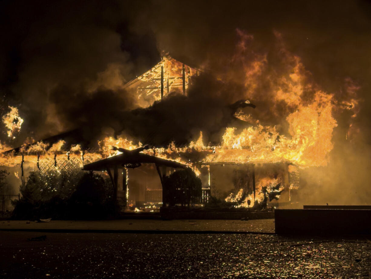 FILE - A building burns after a Russian strike in Mykolaiv, Ukraine, on Oct. 15, 2024.