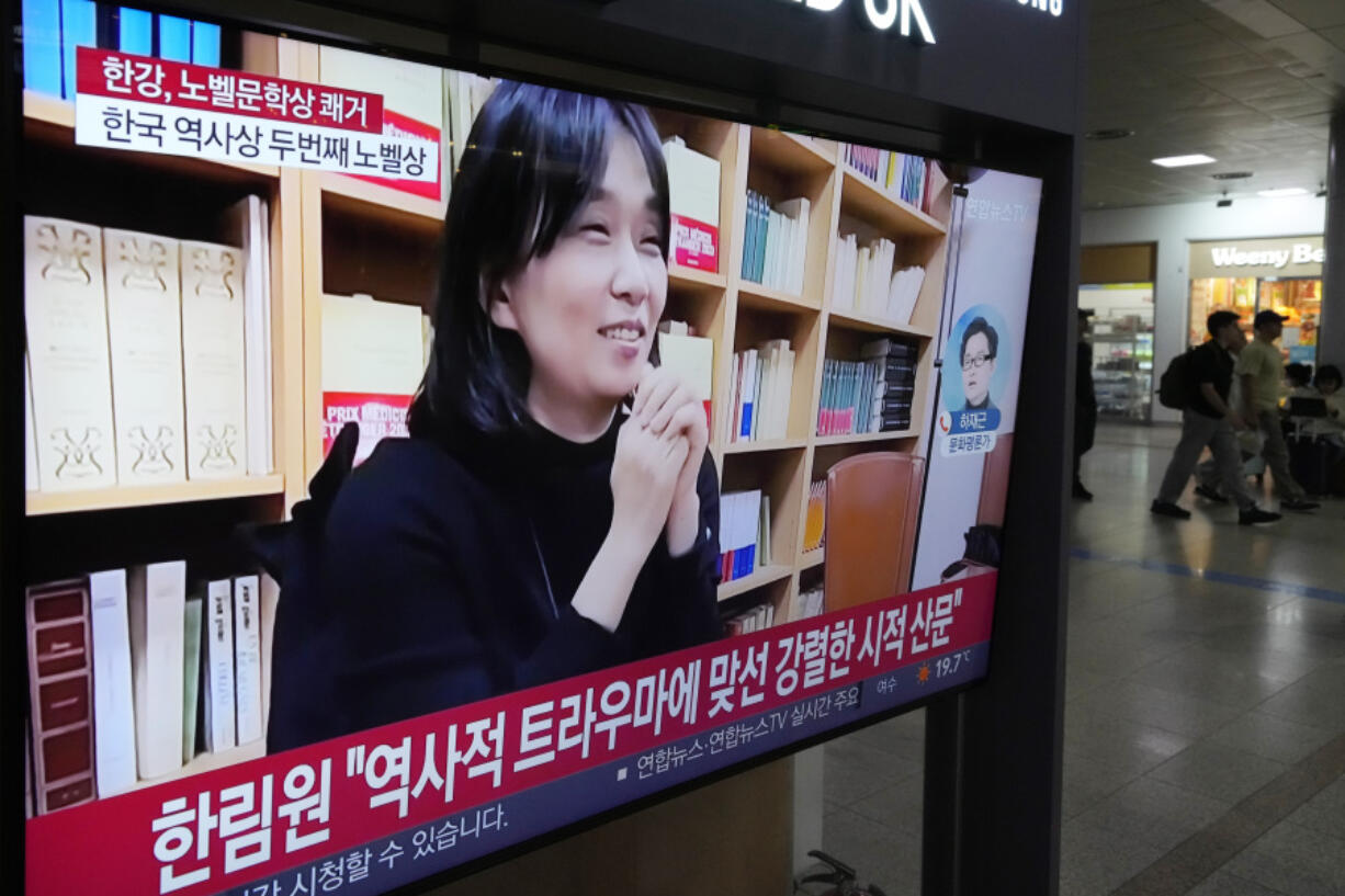 A TV screen shows an image of the winner of the 2024 Nobel Prize in Literature, South Korean writer Han Kang, during a news program at Seoul Railway Station in Seoul, South Korea, Thursday, Oct. 10, 2024.