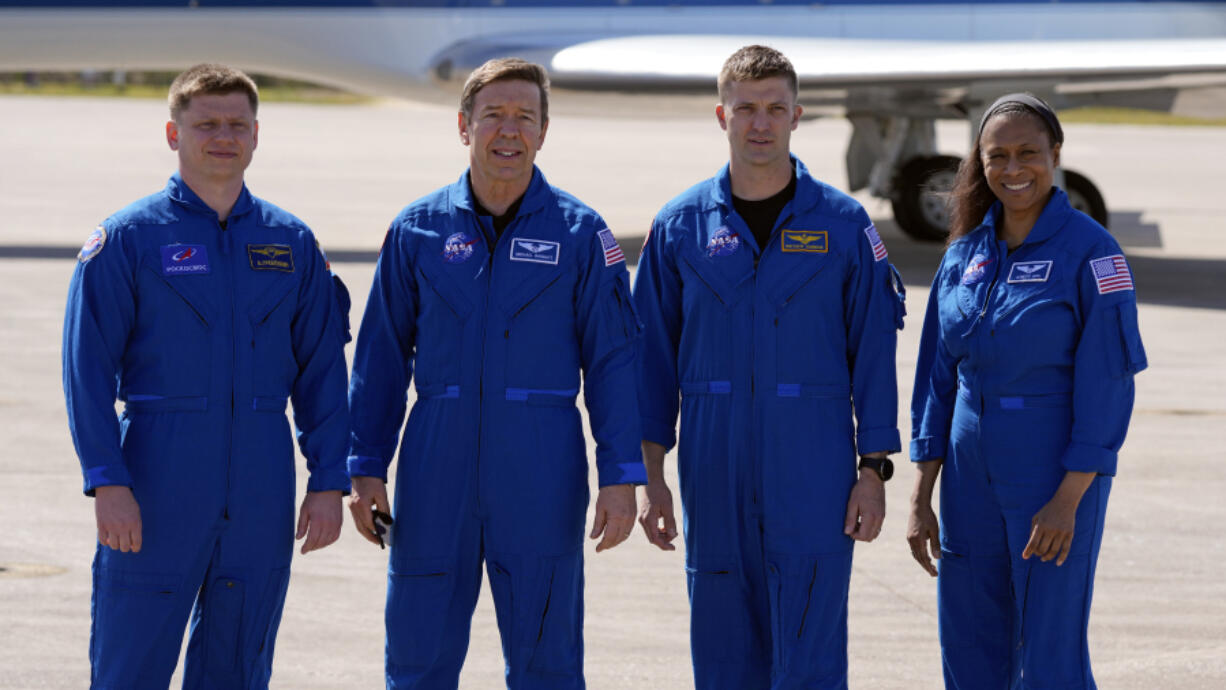 The SpaceX crew of the Dragon spacecraft, from left, cosmonaut Alexander Grebenkin, pilot Michael Barratt, commander Matthew Dominick and mission specialist Jeanette Epps gather for a photo after arriving at the Kennedy Space Center in Cape Canaveral, Fla., Sunday, Feb. 25, 2024.