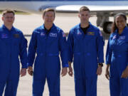 The SpaceX crew of the Dragon spacecraft, from left, cosmonaut Alexander Grebenkin, pilot Michael Barratt, commander Matthew Dominick and mission specialist Jeanette Epps gather for a photo after arriving at the Kennedy Space Center in Cape Canaveral, Fla., Sunday, Feb. 25, 2024.