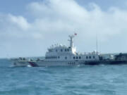 In this screen grab from video released by the Taiwan Coast Guard, a view of a China Coast Guard boat from a Taiwan Coast Guard boat as it passes near the coast of Matsu islands, Taiwan on Monday, Oct. 14, 2024.