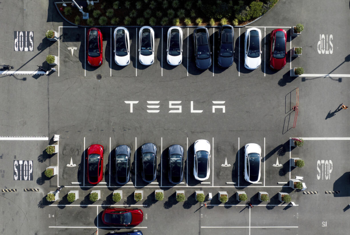 FILE - Tesla vehicles line a parking lot at the company&rsquo;s Fremont, Calif., factory, on Sept. 18, 2023.