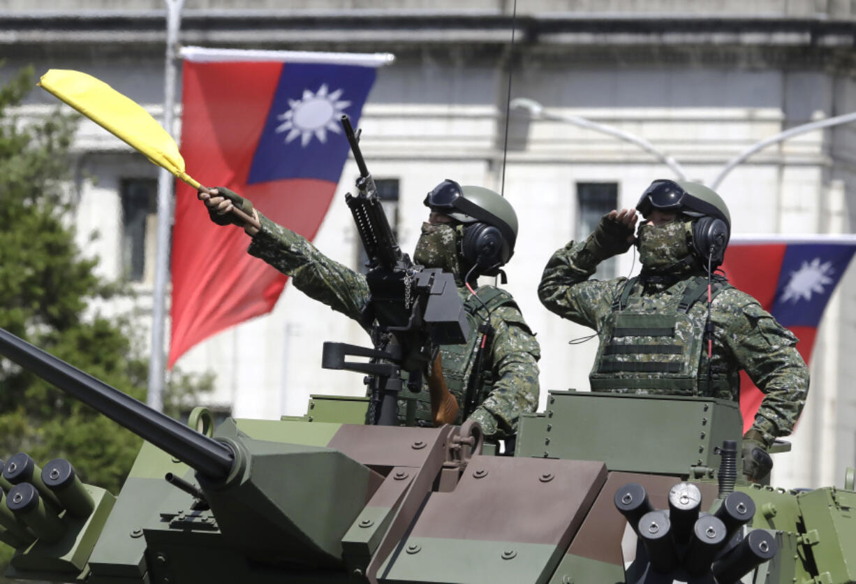 Taiwanese soldiers salute during National Day celebrations in front of the Presidential Building in Taipei, Taiwan, on Oct. 10, 2021.