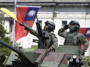 Taiwanese soldiers salute during National Day celebrations in front of the Presidential Building in Taipei, Taiwan, on Oct. 10, 2021.