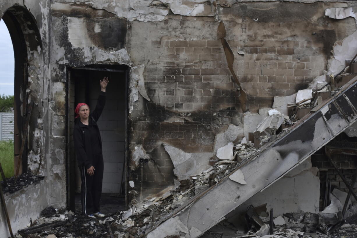 FILE - Valentina, 53, a local woman, stands inside the Evangelical Christian Baptists prayer house in Orihiv, Ukraine, on Monday, May 22, 2023, which was destroyed the previous day by a Russian attack.