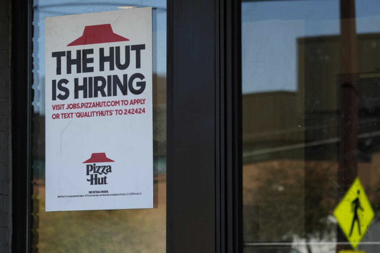 A hiring sign is displayed at a restaurant in Buffalo Grove, Ill., Tuesday, Oct. 8, 2024. (AP Photo/Nam Y.