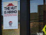 A hiring sign is displayed at a restaurant in Buffalo Grove, Ill., Tuesday, Oct. 8, 2024. (AP Photo/Nam Y.