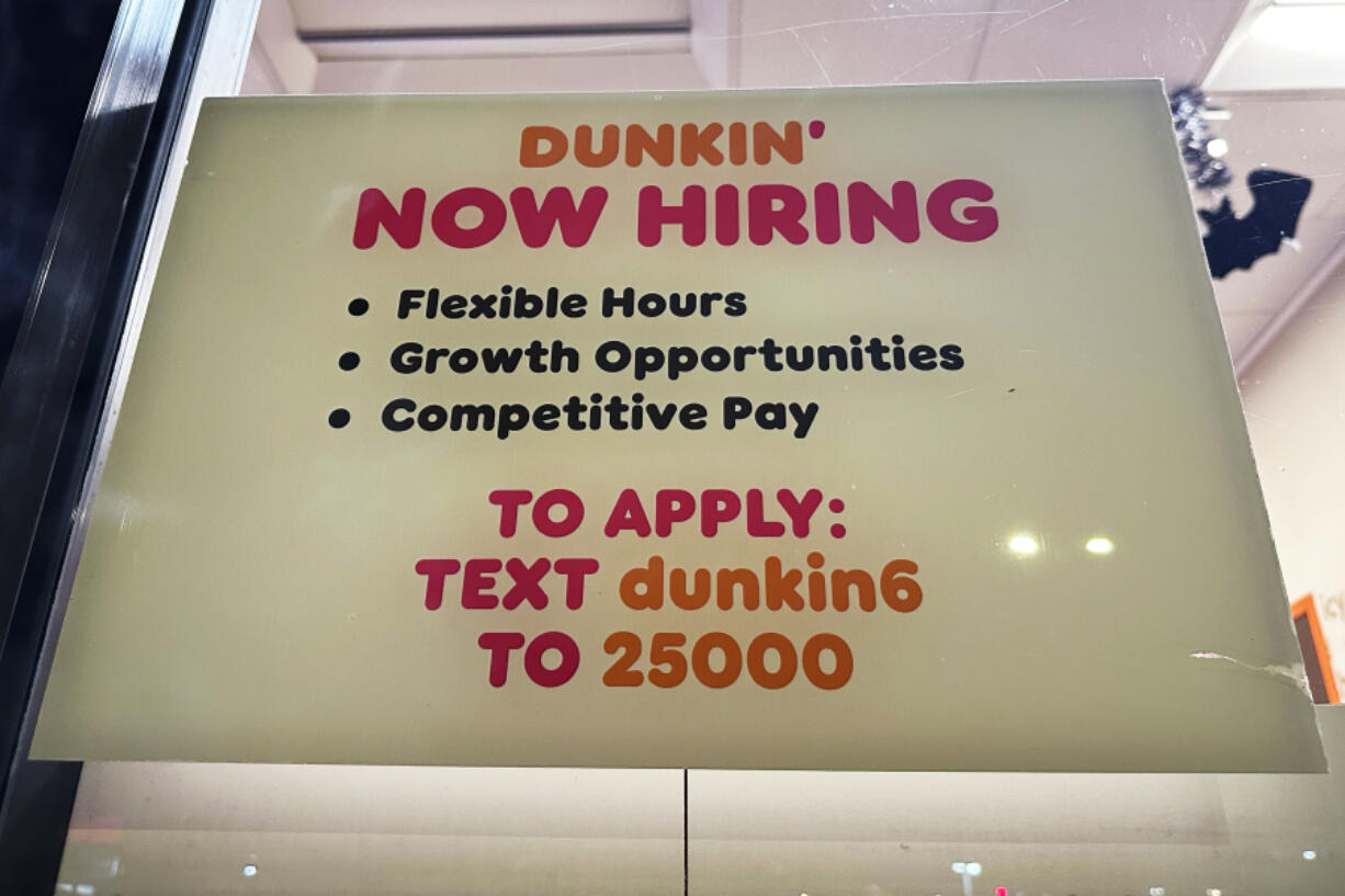 A hiring sign is displayed at a Dunkin&rsquo; in Glenview, Ill., Tuesday, October. 1, 2024. (AP Photo/Nam Y.