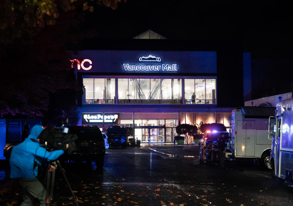 Police lights illuminate the food court entrance to Vancouver Mall after a shooting on Thursday, Oct. 31, 2024.