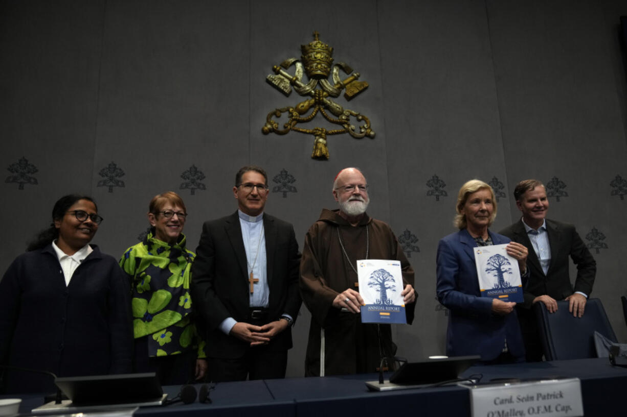 From left, Sister Niluka Perera, Teresa Morris Kettelkamp, Monsignior Luis Herrera, Cardinal Sean Patrick O&rsquo; Malley, jurist Maud de Boer-Buquicchio and clergy sex abuse survivor and victim&rsquo;s advocate Juan Carlos Cruz, pose for a photo at the end of a press conference to present the Vatican&rsquo;s first Annual Global Report on Minors Protection at the Vatican press center, Tuesday, Oct. 29, 2024.