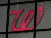 A Walgreens logo is seen from the exterior of a store in Wheeling, Ill., Tuesday, Oct. 15, 2024. (AP Photo/Nam Y.