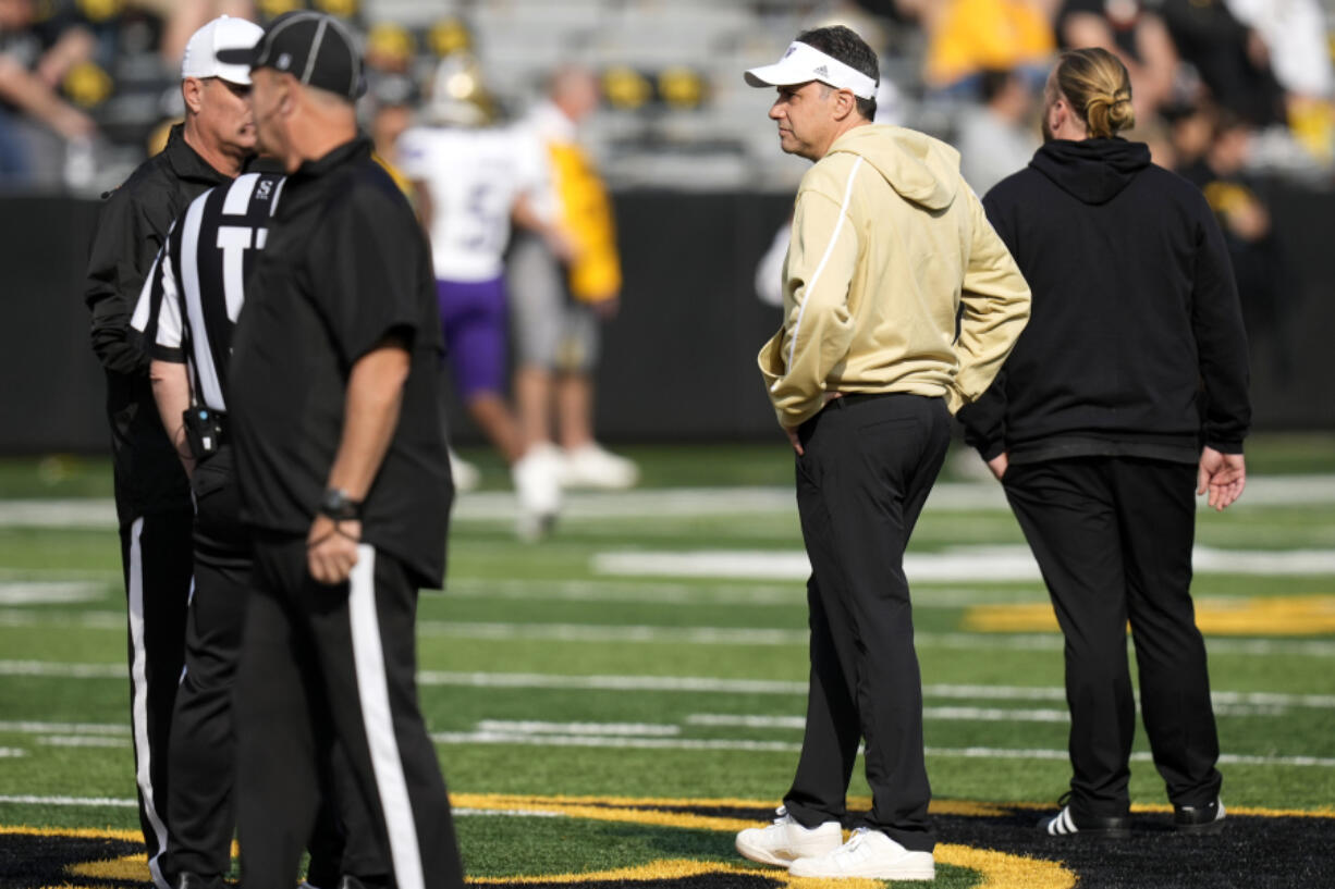 Washington head coach Jedd Fisch, right, stands on the field before an NCAA college football game against Iowa, Saturday, Oct. 12, 2024, in Iowa City, Iowa.