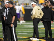 Washington head coach Jedd Fisch, right, stands on the field before an NCAA college football game against Iowa, Saturday, Oct. 12, 2024, in Iowa City, Iowa.