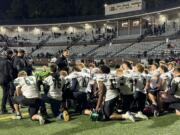 Woodland football coach Glen Flanagan, center, addresses his team after a 49-15 win over Hudson's Bay on Friday, Oct. 18, 2024 at Kiggins Bowl.