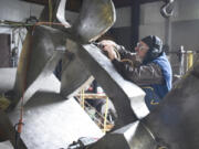 Sculptor James Lee Hansen works on a sculpture called &ldquo;The Sky Skipper&rdquo; in 2017 at his home studio near Daybreak Park.