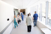 People touring the new emergency room building at PeaceHealth Southwest Medical Center in Vancouver walk down a second floor hallway June 28.