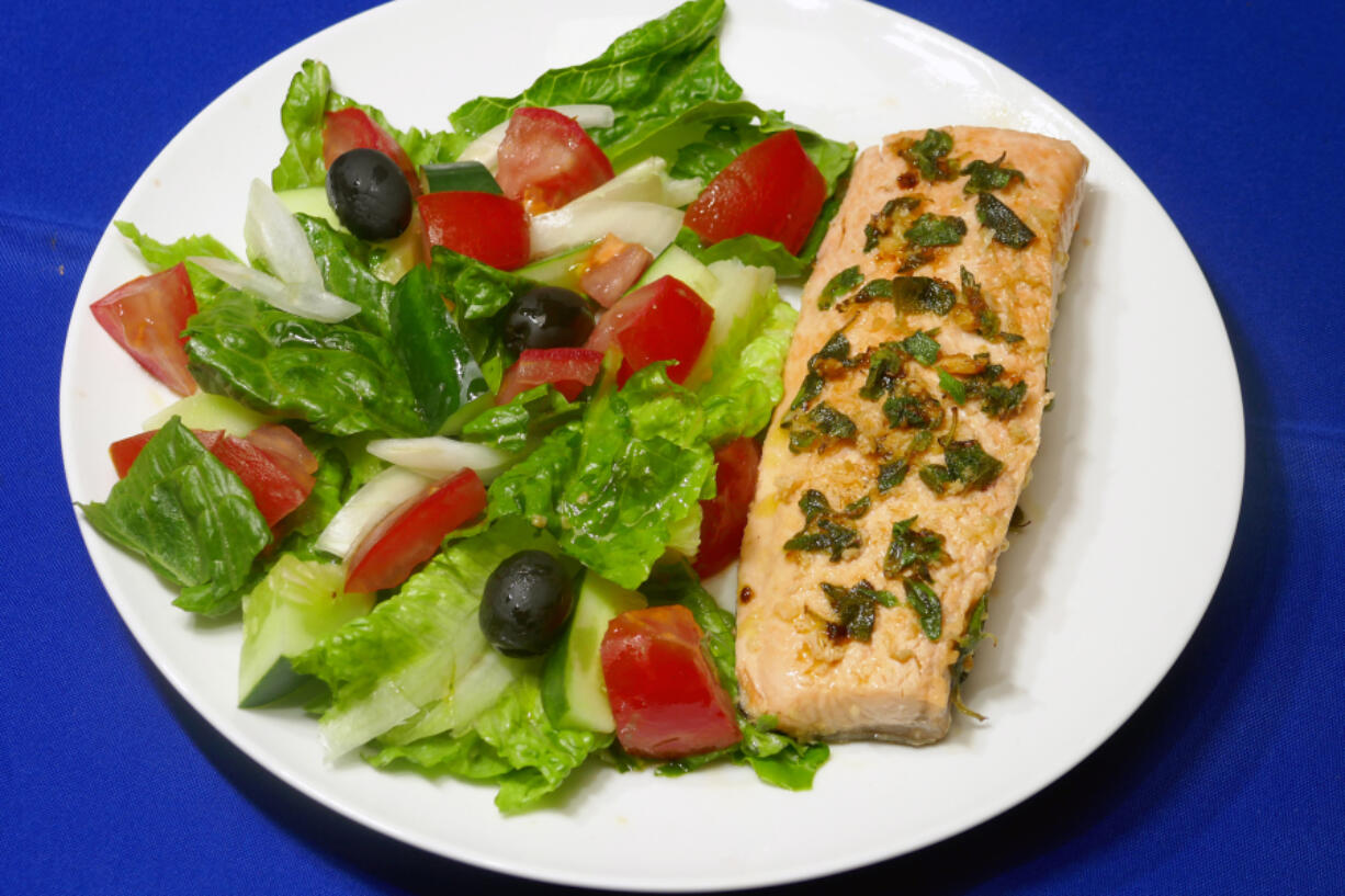 Greek salad with salmon sauteed in an olive oil, lemon and garlic sauce.