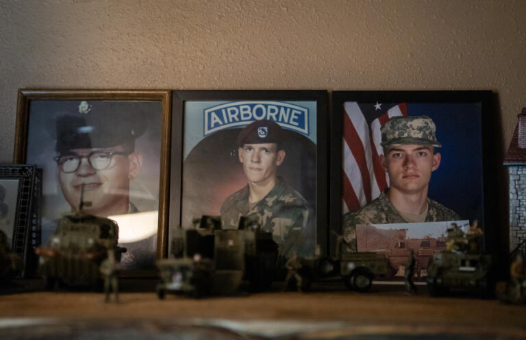 Photos of Thomas Renner Sr., left, and others sit on a shelf at the Renner residence in Woodland.