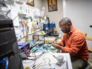 Sustainable Power and Water Engineering Solutions founder Geb Mengistu works on soldering a driver in Mengistu&rsquo;s garage. The company is part of a growing renewable energy job sector here in Clark County.