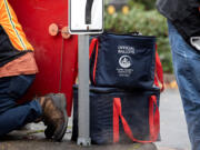 Official ballots are collected by elections officials in secure bags in downtown Vancouver on Monday afternoon, Nov. 4, 2024.