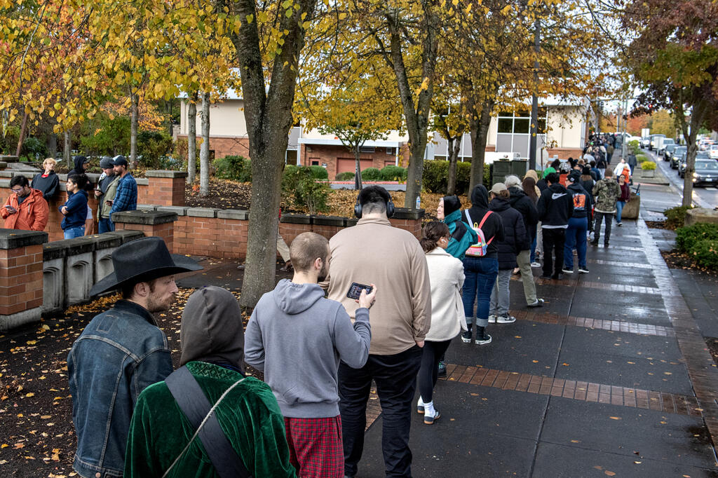 A long line of voters reaches the courtyard of the public service center as people wait to vote in person at the elections office in downtown Vancouver on Tuesday afternoon, Nov. 5, 2024.