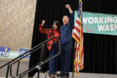 Rep. Marie Gluesenkamp Perez, left, joins Democrat Tim Probst as they celebrate early election results after speaking to the crowd at an election night party at the Hilton Vancouver on Tuesday night, Nov. 5, 2024.