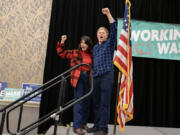 Rep. Marie Gluesenkamp Perez, left, joins Democrat Tim Probst as they celebrate early election results after speaking to the crowd at an election night party at the Hilton Vancouver on Tuesday night, Nov. 5, 2024.