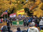 Vietnamese Community of Clark County members hold flags and march Monday during the 36th Annual Lough Legacy Veterans Parade at Fort Vancouver National Historic Site.