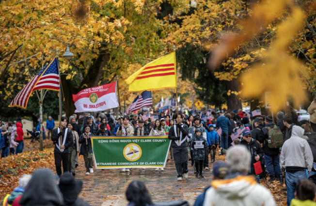 Vietnamese Community of Clark County members hold flags and march Monday during the 36th Annual Lough Legacy Veterans Parade at Fort Vancouver National Historic Site.