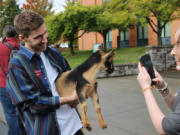 Jacob Winstead, president of Washington State University Vancouver&rsquo;s student association, holds a baby pigmy goat during a &ldquo;Pet a Goat &ndash; Register to Vote&rdquo; event Monday on campus. Winstead said younger voters are showing more interest in this year&rsquo;s election than in prior years.