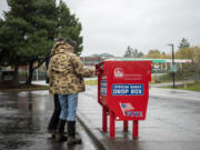 U.S. Rep. Marie Gluesenkamp Perez, D-Skamania, foreground, and her husband Dean Gluesenkamp cast their ballots at the Fisher&rsquo;s Landing ballot drop box on Friday. The box was the site of arson on Monday that damaged almost 500 ballots.