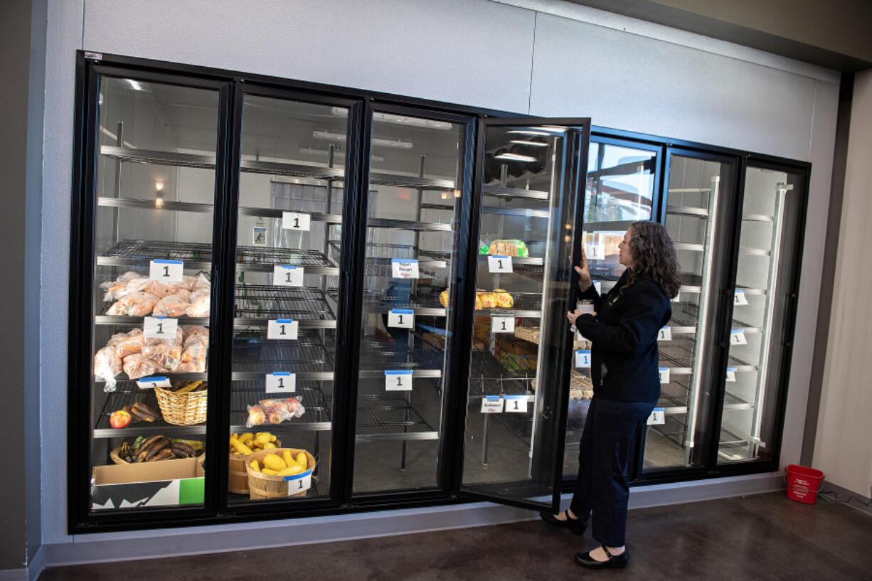 Demetria Edwards of the Clark County Food Bank&rsquo;s new Vision Center looks over a walk-in cooler with retail doors during a tour of the facility Thursday afternoon. The 13,000-square-foot project will be able to distribute 27,000 pounds of food a month, as well as provide nutrition and cooking classes.