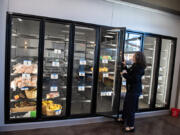 Demetria Edwards of the Clark County Food Bank&rsquo;s new Vision Center looks over a walk-in cooler with retail doors during a tour of the facility Thursday afternoon. The 13,000-square-foot project will be able to distribute 27,000 pounds of food a month, as well as provide nutrition and cooking classes.