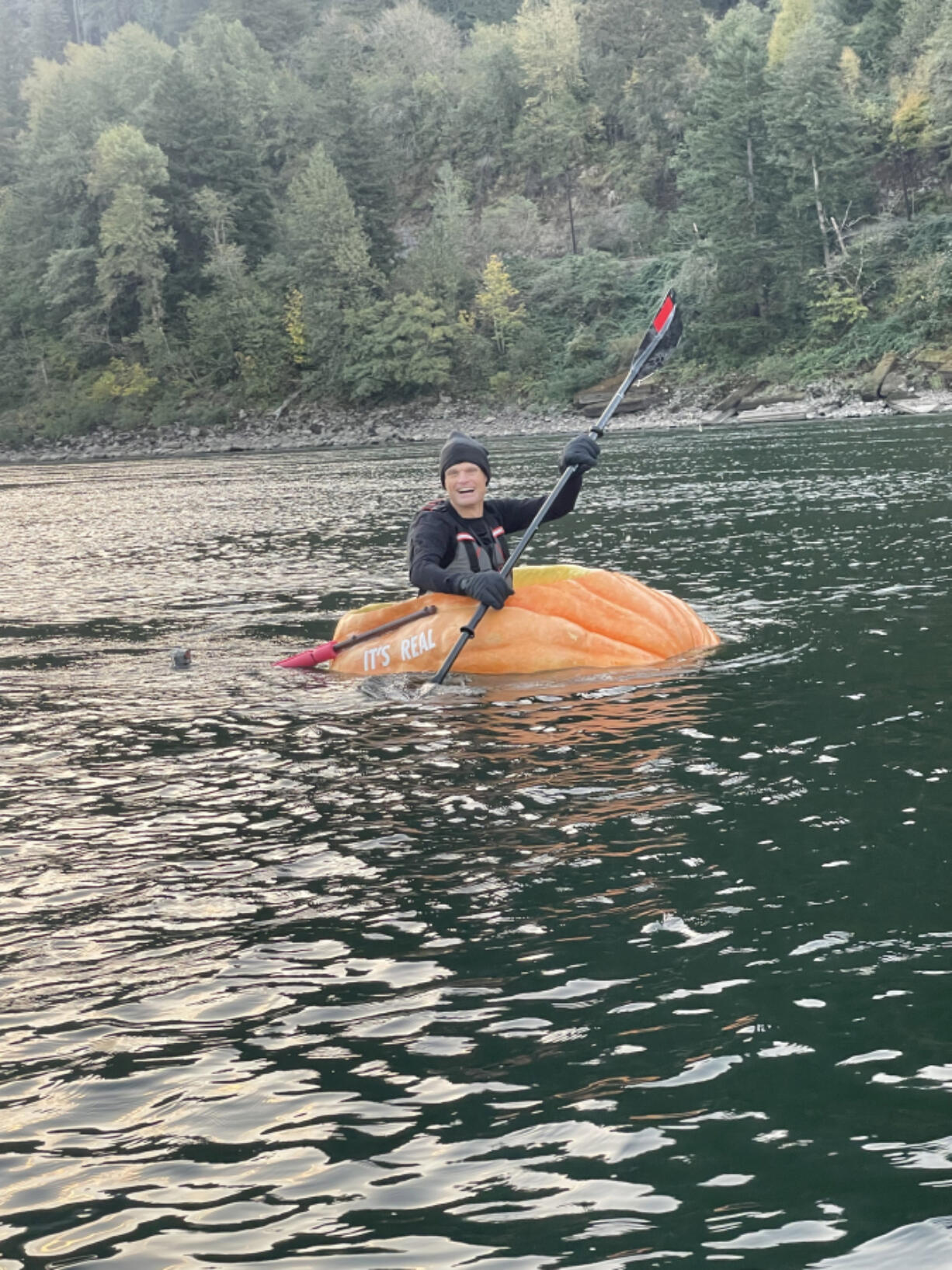 Gary Kristensen paddles his giant pumpkin down the Columbia River.